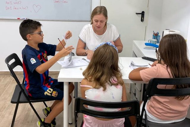 Alumnos practicando conversación en inglés en un ambiente divertido y motivador